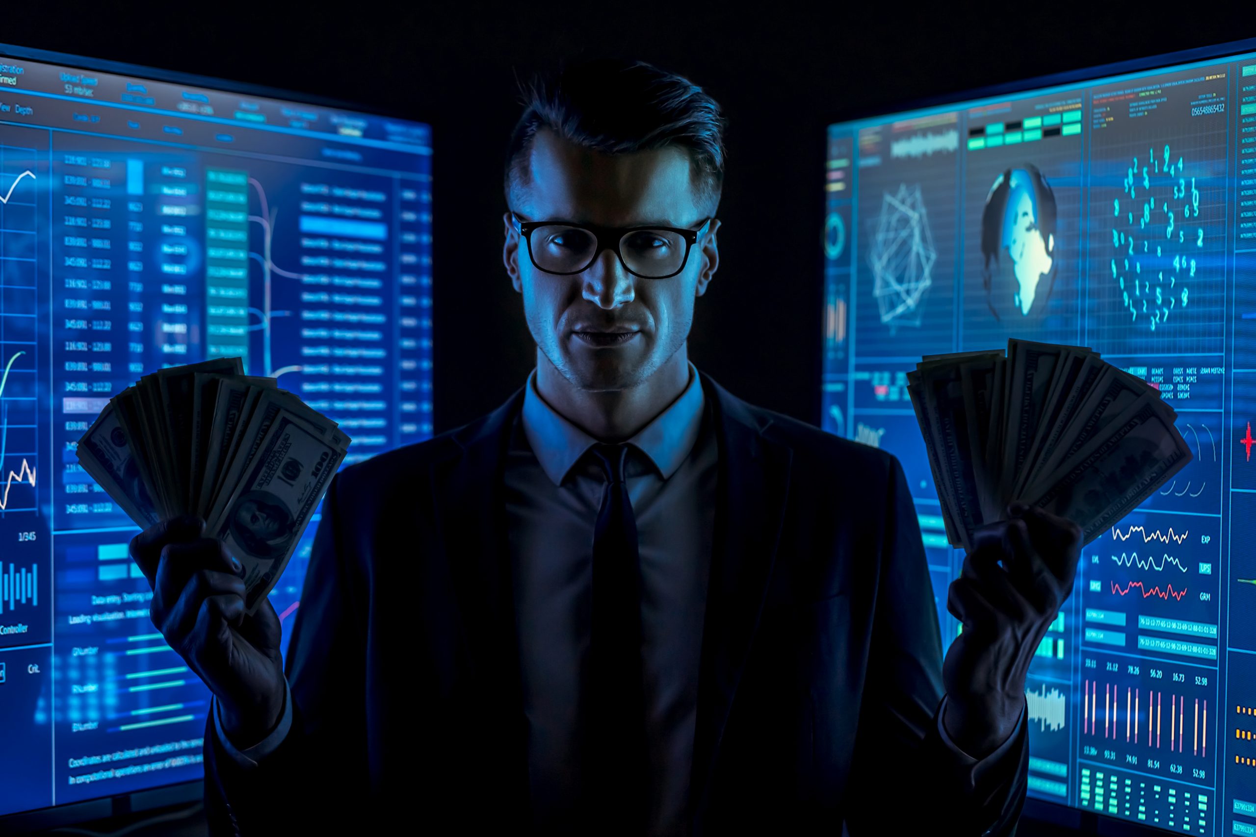 The businessman in suit holds money in a dark lab