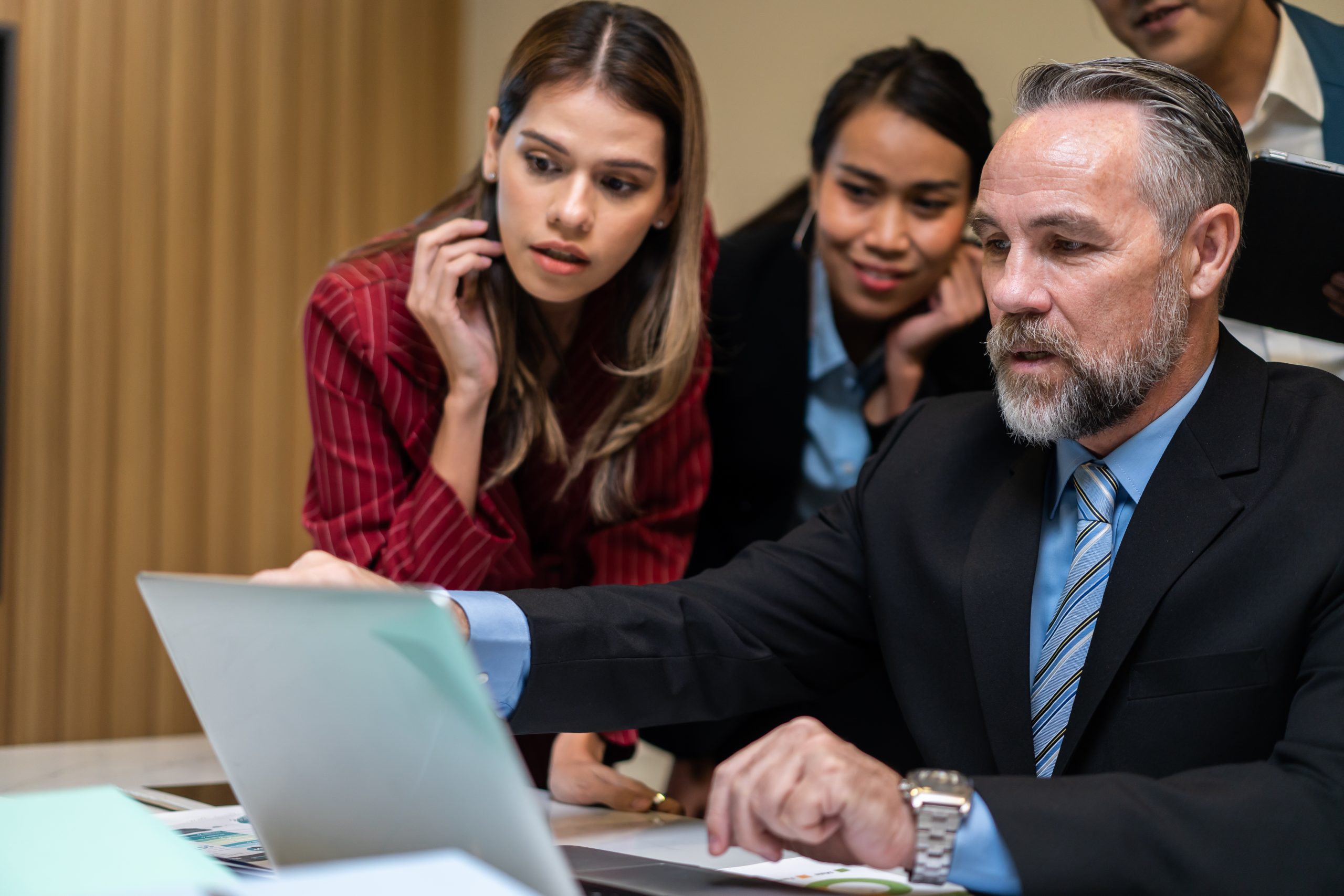 Group of multi-Ethnic businessman and businesswoman working in office. Attractive employee brainstorm and meeting as team, plan and discuss project in workplace. Corporate of modern colleagues concept